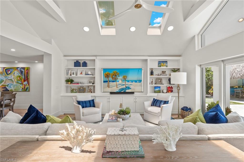 1960 Tarpon Road Naples, FL 34102 - Photo 18 of 49 a living room with furniture and book shelf