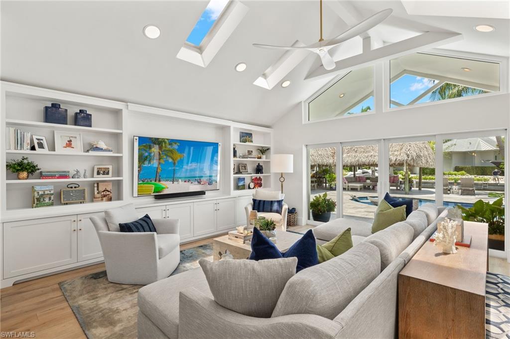 1960 Tarpon Road Naples, FL 34102 - Photo 22 of 49 a living room with furniture and a floor to ceiling window