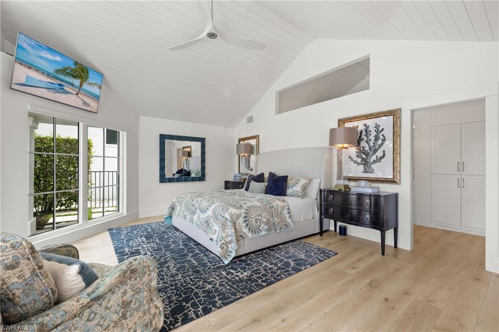 1960 Tarpon Road Naples, FL 34102 - Photo 25 of 49 a bedroom with a large bed and a window