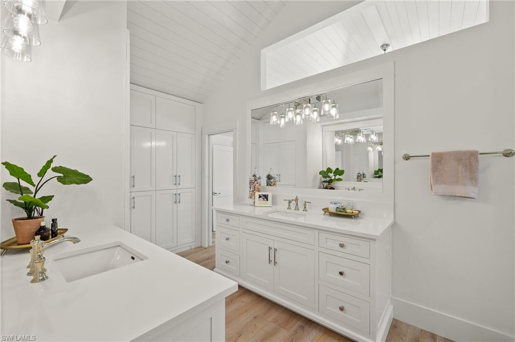 1960 Tarpon Road Naples, FL 34102 - Photo 29 of 49 a spacious bathroom with a double vanity sink and mirror