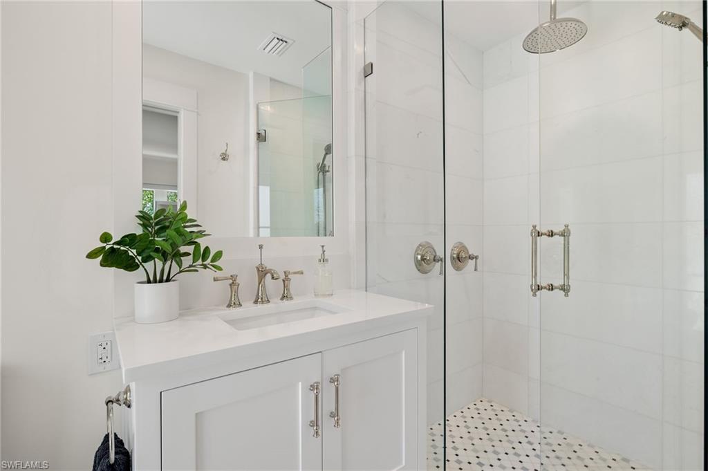 1960 Tarpon Road Naples, FL 34102 - Photo 33 of 49 a bathroom with a sink and a mirror