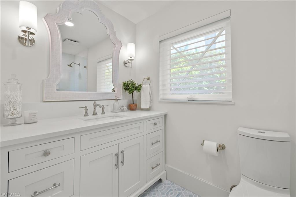 1960 Tarpon Road Naples, FL 34102 - Photo 36 of 49 a bathroom with a granite countertop sink mirror and a toilet