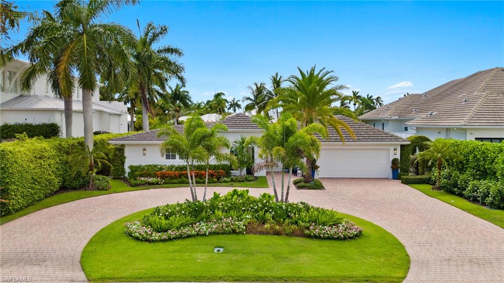 1960 Tarpon Road Naples, FL 34102 - Photo 47 of 49 a front view of a house with a garden