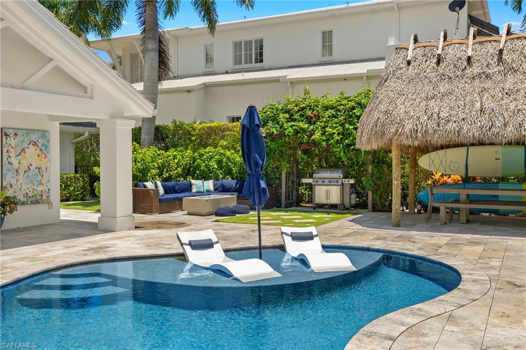 1960 Tarpon Road Naples, FL 34102 - Photo 5 of 49 a view of a house with swimming pool and sitting area