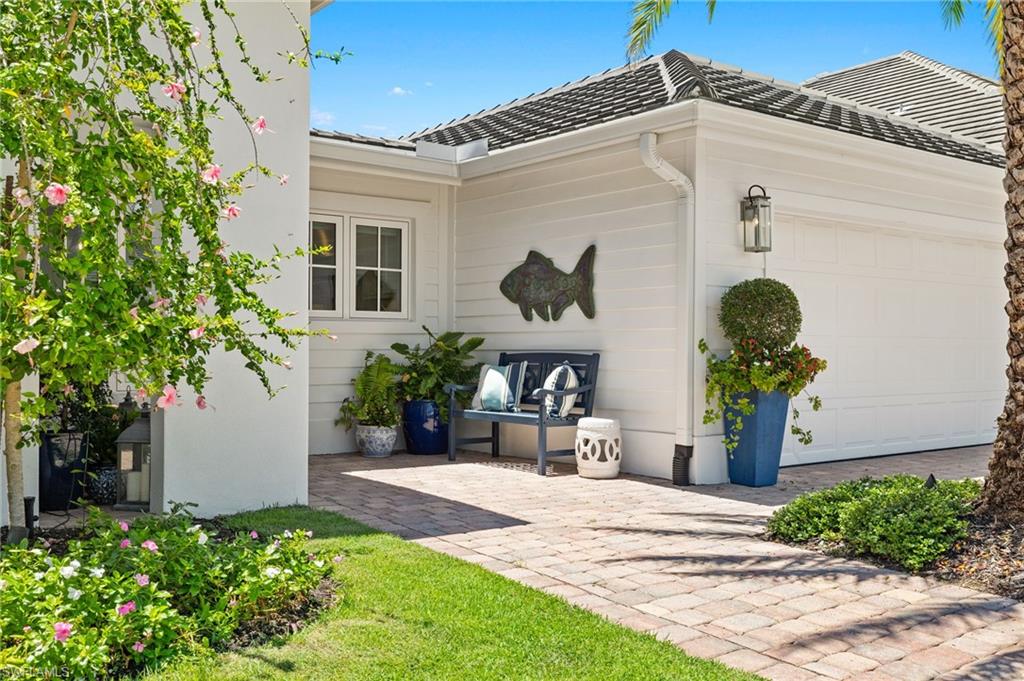 1960 Tarpon Road Naples, FL 34102 - Photo 9 of 49 a front view of a house with garden