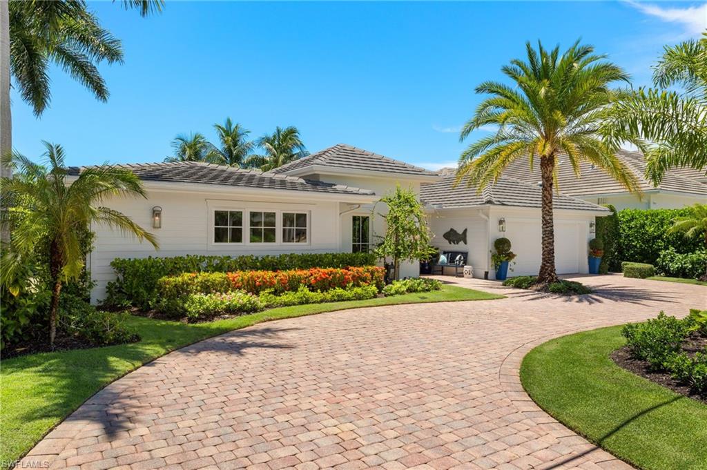 1960 Tarpon Road Naples, FL 34102 - Photo 10 of 49 a front view of a house with a yard and potted plants