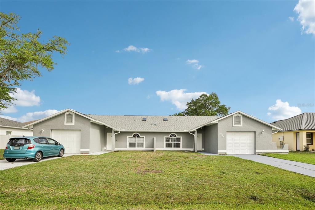 734 Bittern Lane Kissimmee, FL 34759 - Photo 1 of 1 a big house with a big yard and large trees