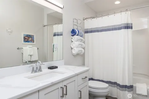 a kitchen with a sink a microwave a refrigerator and chairs