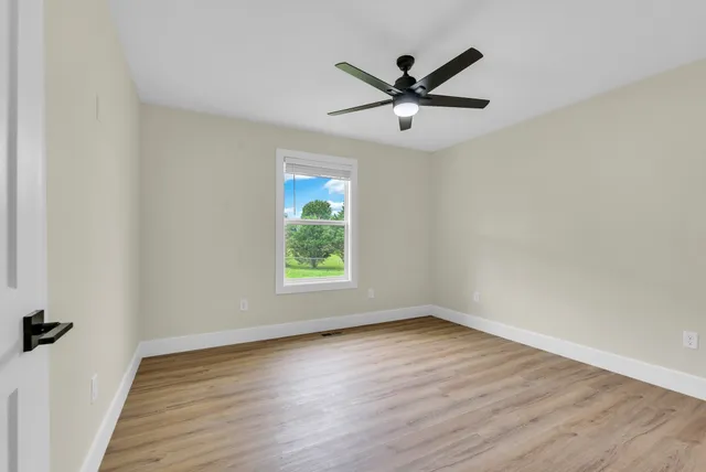 a large kitchen with kitchen island a stove a sink dishwasher and a refrigerator with wooden floor