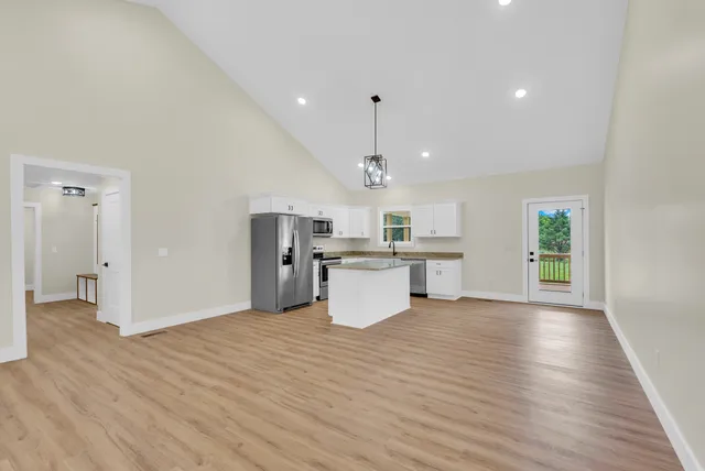 a view of a kitchen with a sink and a ceiling fan