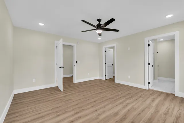 a view of a room with wooden floor