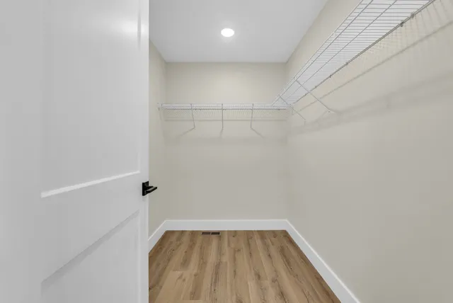 a bathroom with a granite countertop sink a mirror and a shower