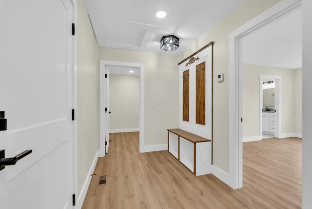 a view of empty room with wooden floor