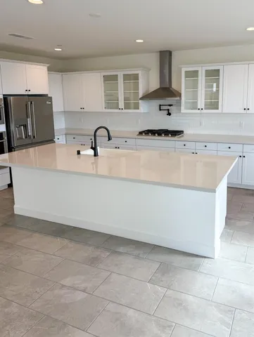 a large white kitchen with cabinets