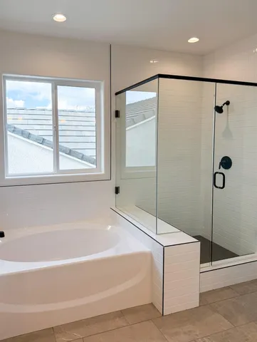 a bathroom with a bathtub and a shower