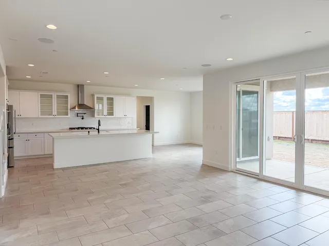 a large white kitchen with a sink and cabinets