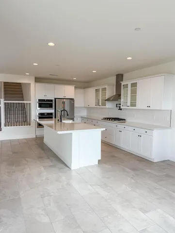a large kitchen with stainless steel appliances lots of counter top space