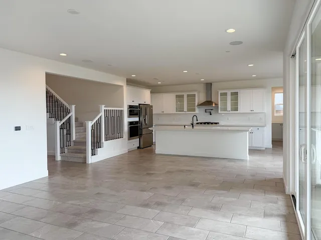 a view of large kitchen with a sink and cabinets