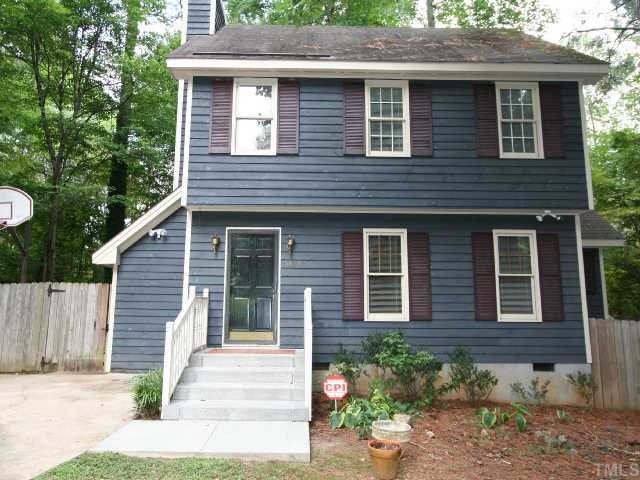 6804 Chamonix Place Raleigh, NC 27613 - Photo 1 of 12 a front view of a house with a garden