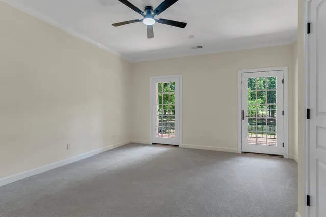 an empty room with a window and a ceiling fan