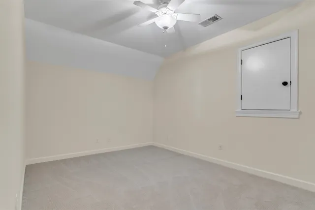 a living room with furniture a rug and white walls