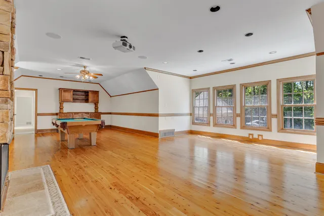 a backyard of a house with a yard and tree