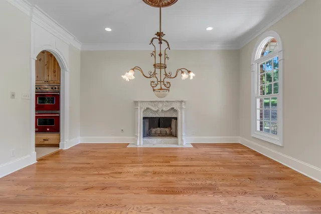 a view of an empty room with a fireplace and a window