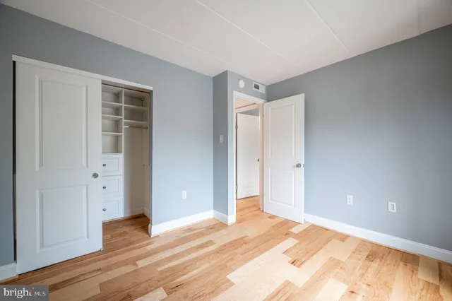 a view of a livingroom with wooden floor and closet
