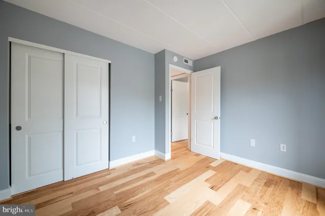 a view of a room with wooden floor
