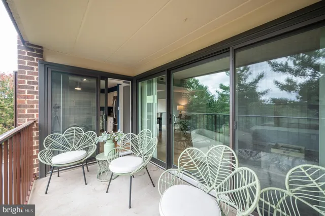 a balcony with chairs and a table