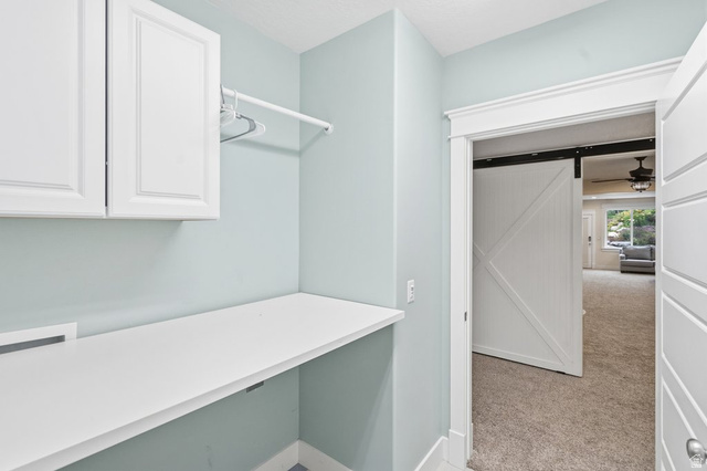 672 Perry Hollow Drive Mapleton, UT 84664 - Photo 80 of 106 Laundry area featuring white shaker-style cabinetry, a white countertop, and a clothes hanging rod