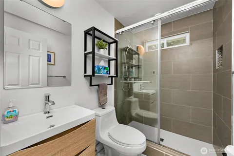 a bathroom with a sink toilet and shower
