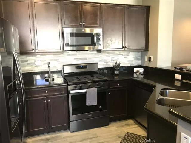 a kitchen with a sink stove and microwave