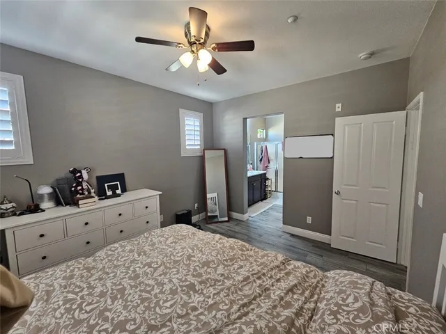 a large bedroom with a bed and a chandelier