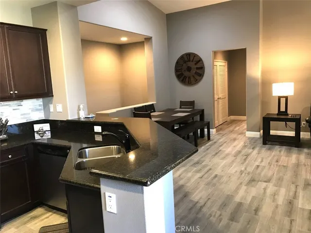 a kitchen with a sink a stove and a refrigerator