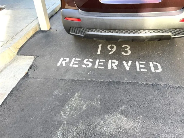 a sign that is sitting on a wooden fence