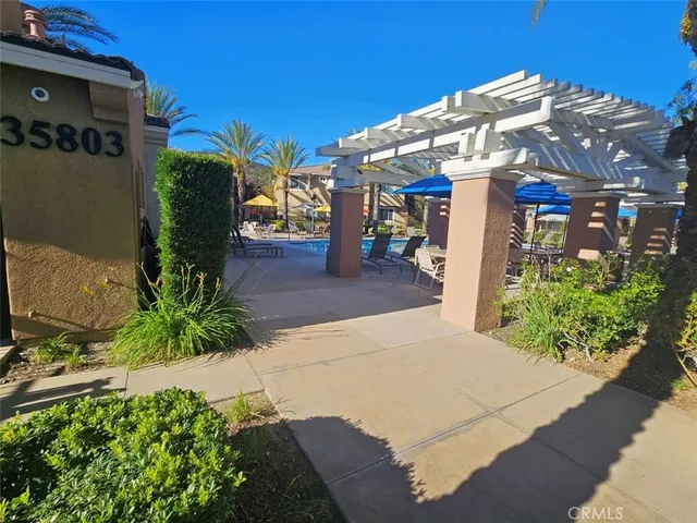 an outdoor space with furniture and umbrella