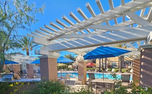 a view of a patio with a dining table and chairs under an umbrella