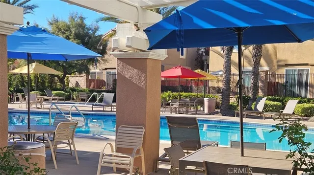 a view of a patio with swimming pool and sitting area