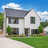 a front view of a house with a garden and porch