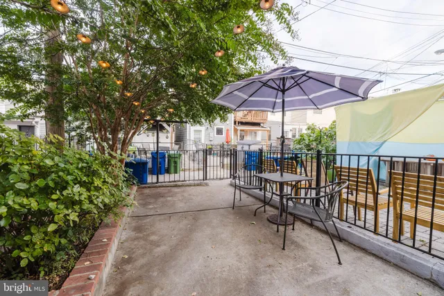 a view of patio with a table and chairs under an umbrella