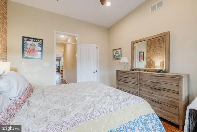 a bed sitting in a bedroom next to a window