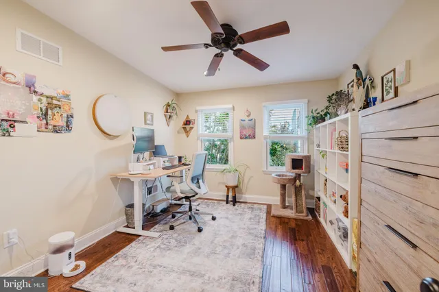 a bathroom with a granite countertop sink a mirror and a shower