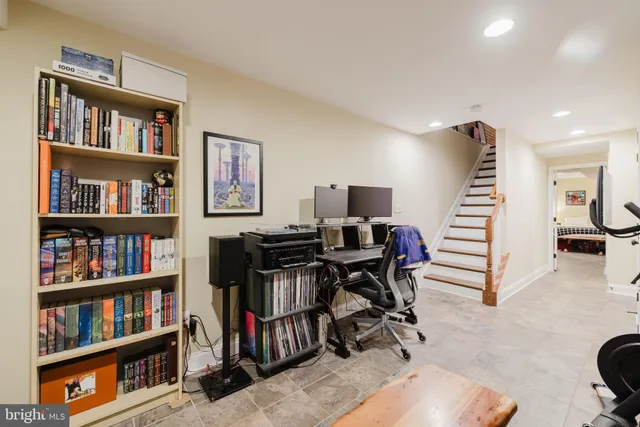 a view of a hallway with wooden floor and entryway