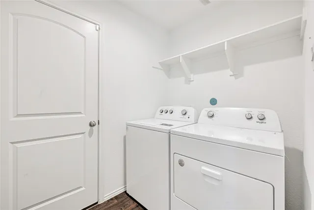 a view of storage and utility room with washer and dryer