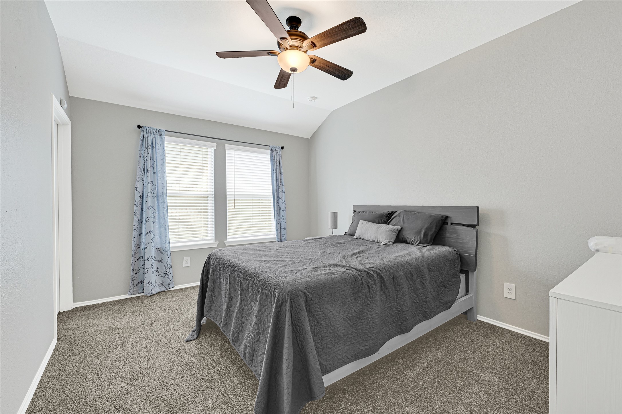 22438 Forest Gorge Lane Spring, TX 77373 - Photo 15 of 20 a spacious bedroom with a bed and a ceiling fan