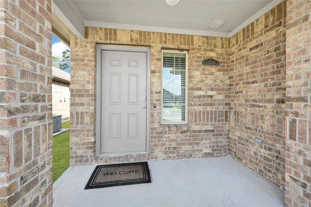 a view of a door with wooden floor and a window