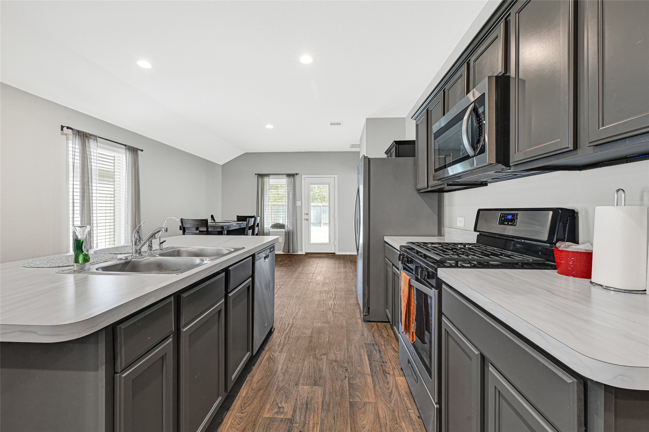 22438 Forest Gorge Lane Spring, TX 77373 - Photo 8 of 20 a kitchen with stainless steel appliances granite countertop a sink stove and cabinets