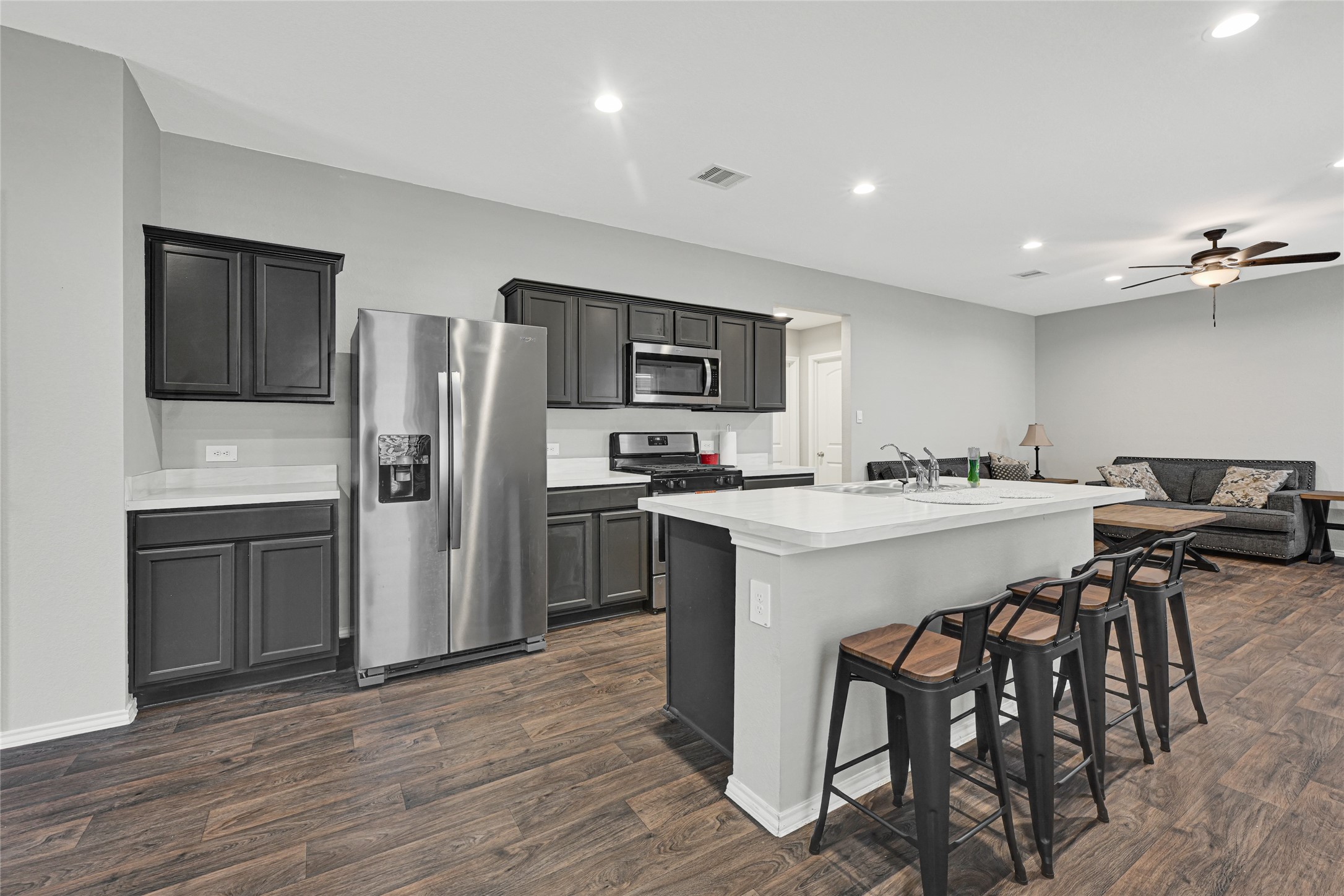 22438 Forest Gorge Lane Spring, TX 77373 - Photo 10 of 20 a kitchen with stainless steel appliances a refrigerator and a stove top oven