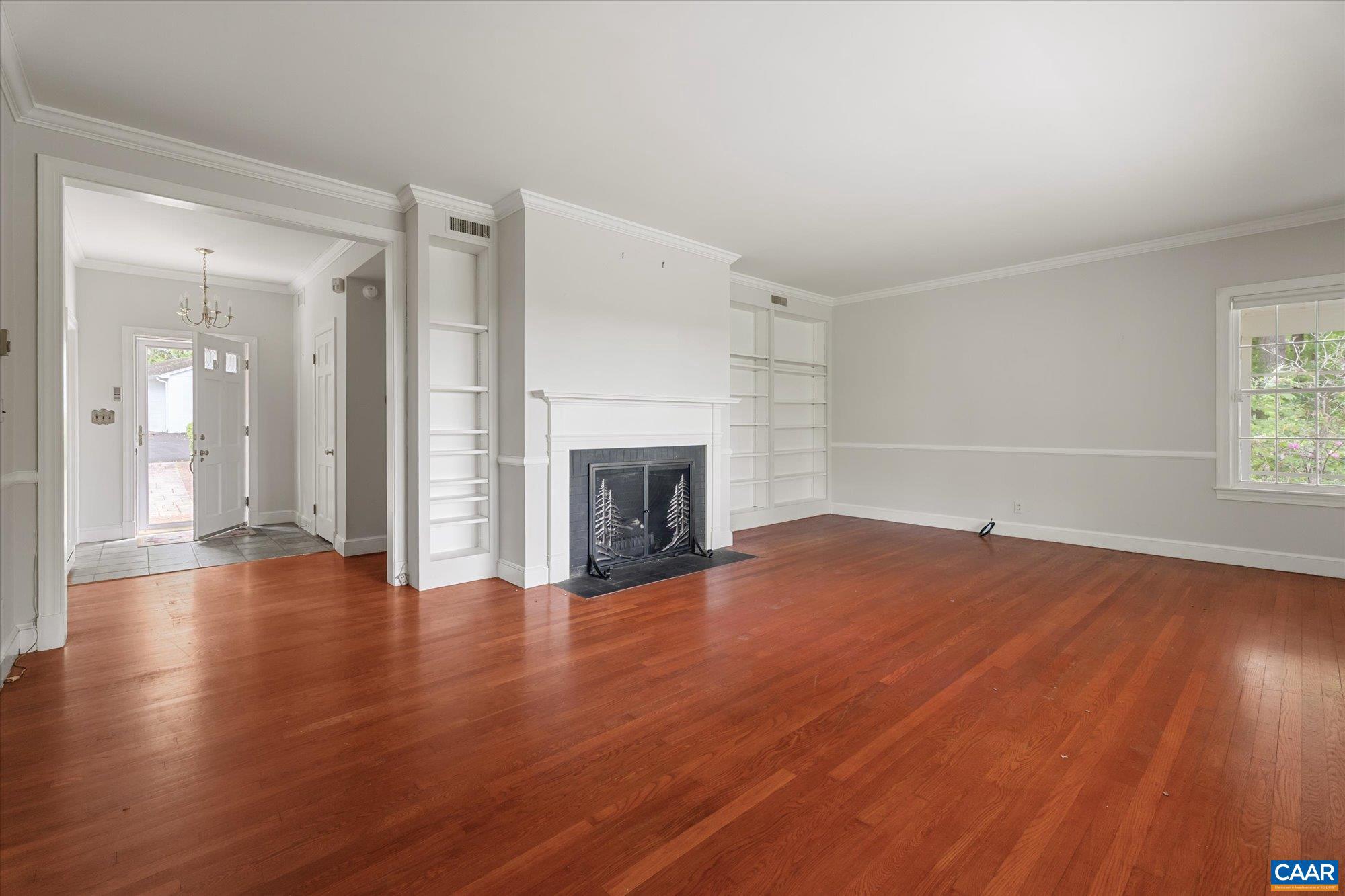 13320 Hackberry Road Orange, VA 22960 - Photo 4 of 47 an empty room with wooden floor fireplace and windows